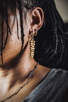 Intricate gold earrings and braided hair create a stunning fashion statement.