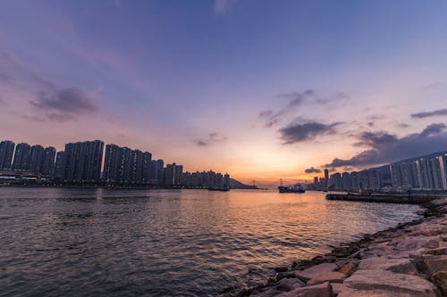 Worm's-eye View of Buildings Beside Body of Water