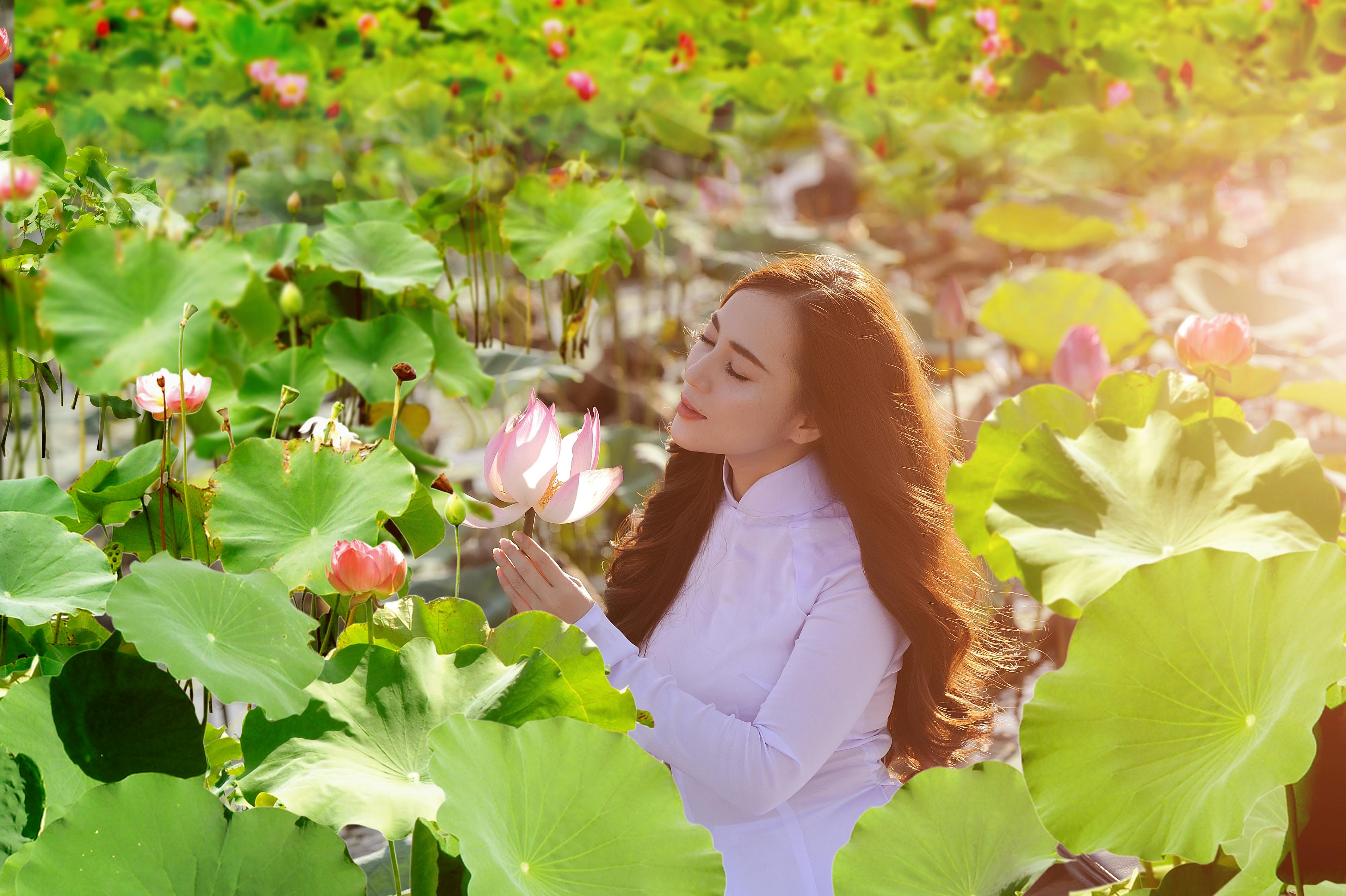 woman in white dress sitting on green grass field