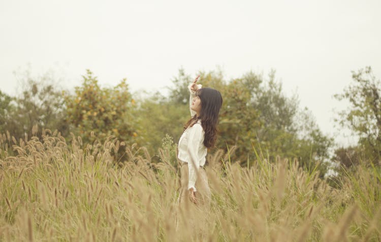 Woman Standing In A Field 