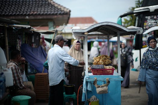 Bustling street food market in Jakarta with vendors and locals engaging in daily commerce.