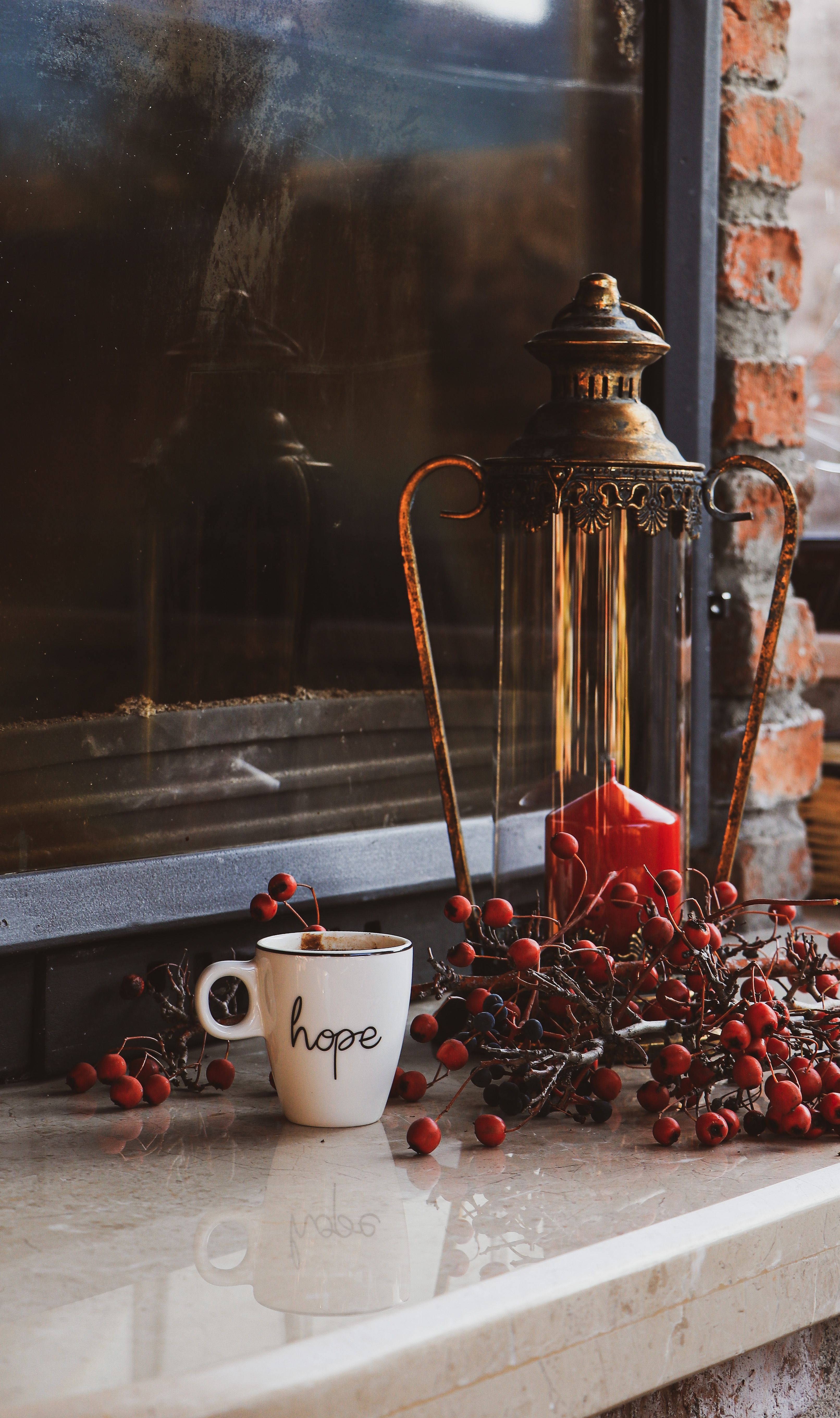 Small candle lanterns placed on a coffee bar counter next to a pour-over setup