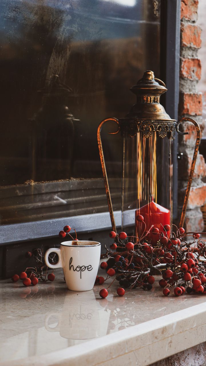 Small candle lanterns placed on a coffee bar counter next to a pour-over setup
