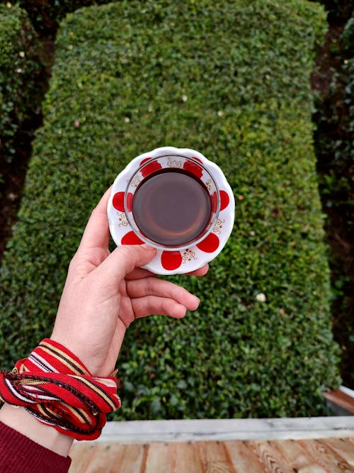 Glass of Tea on Plate in Hand