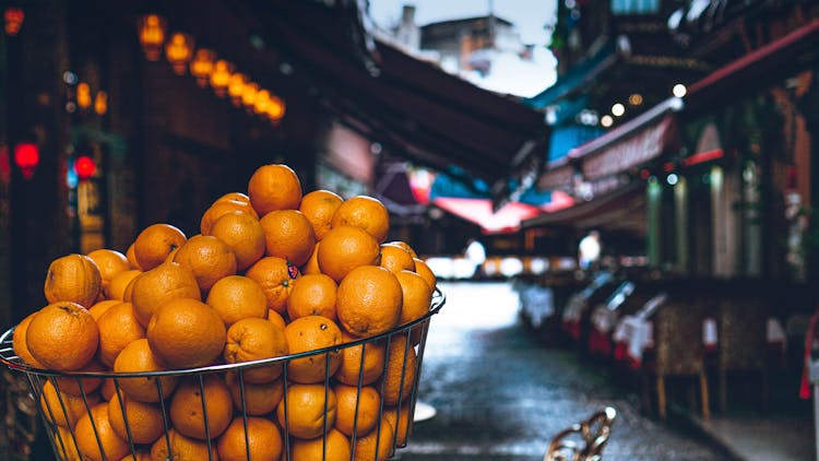 Close-Up Shot Of Fresh Orange Fruits On Metal Basket