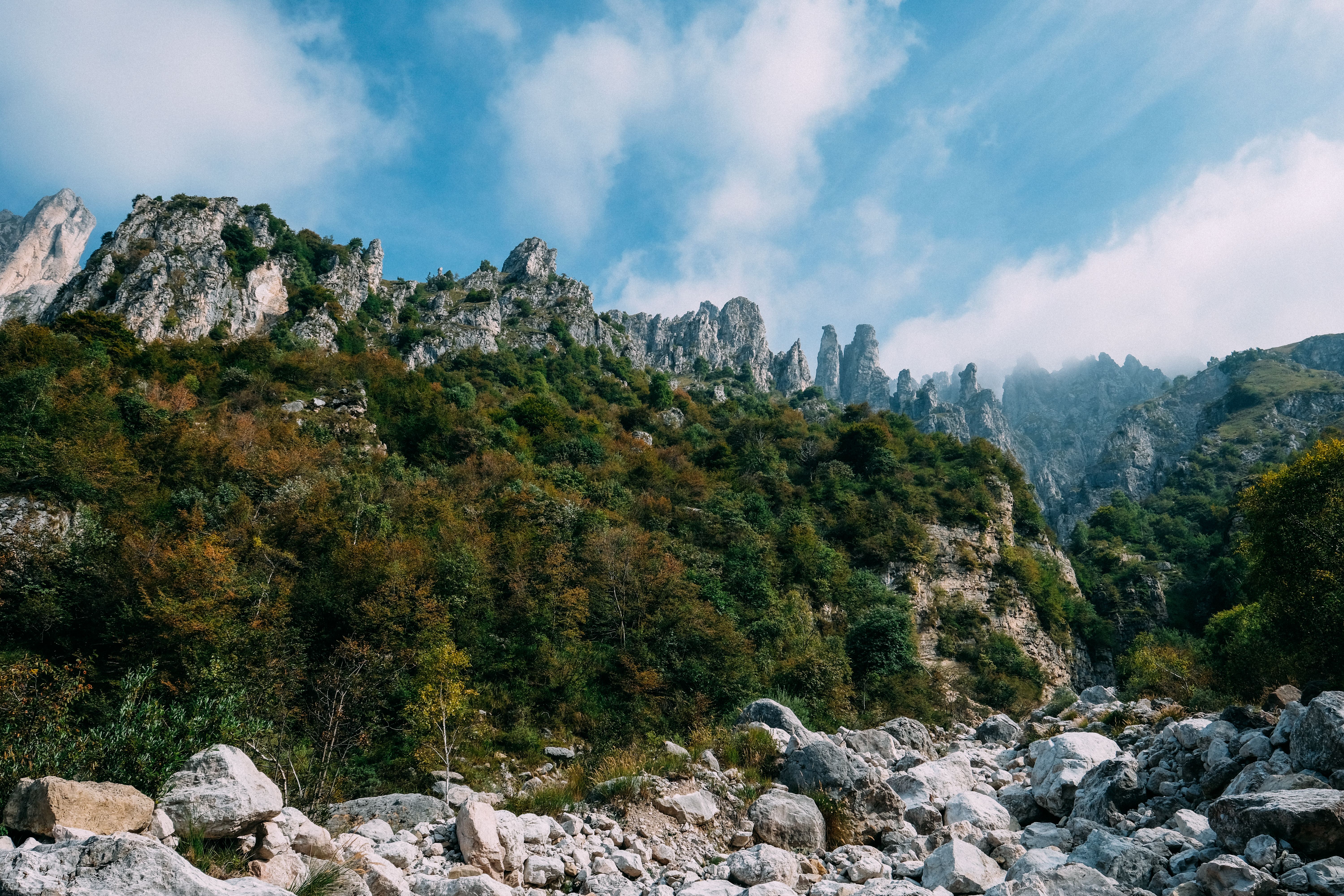 Scenic view of rocky mountain landscape under blue sky, perfect for adventure and travel enthusiasts.