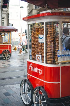 A traditional Turkish simit cart on a busy street in Istanbul, Turkey.