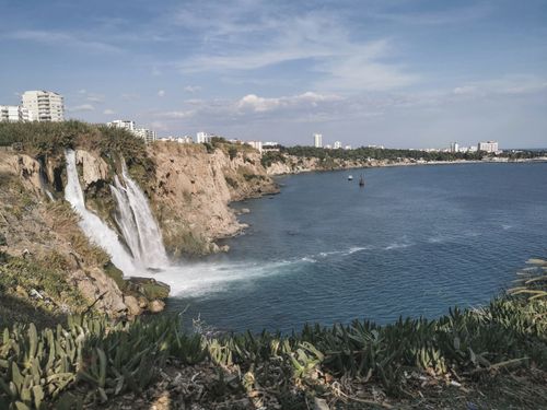 Free A breathtaking view of Düden Waterfalls flowing over the cliffs into the Mediterranean Sea at Antalya, Turkey. Stock Photo