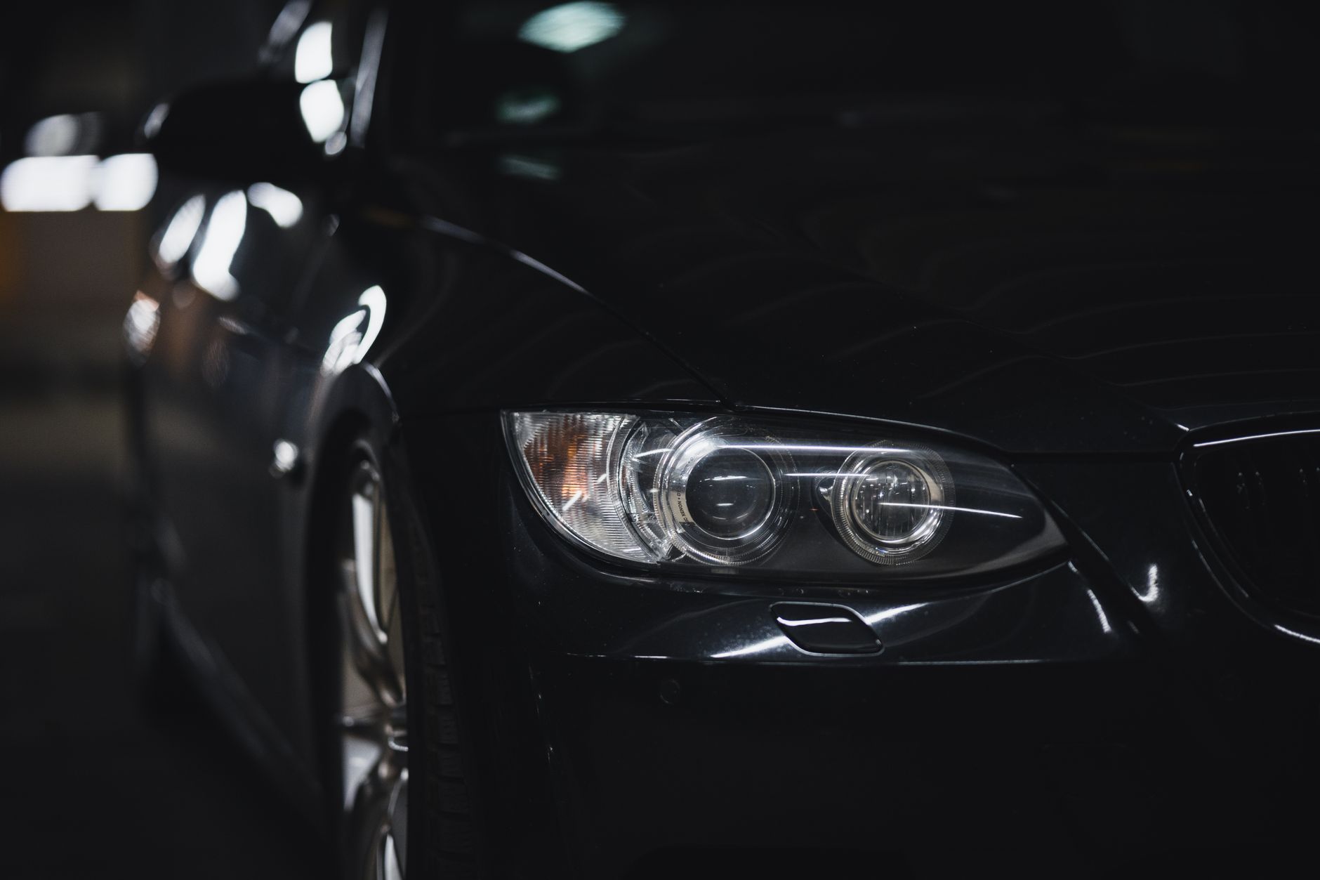 Sleek black car under low light after a full detail
