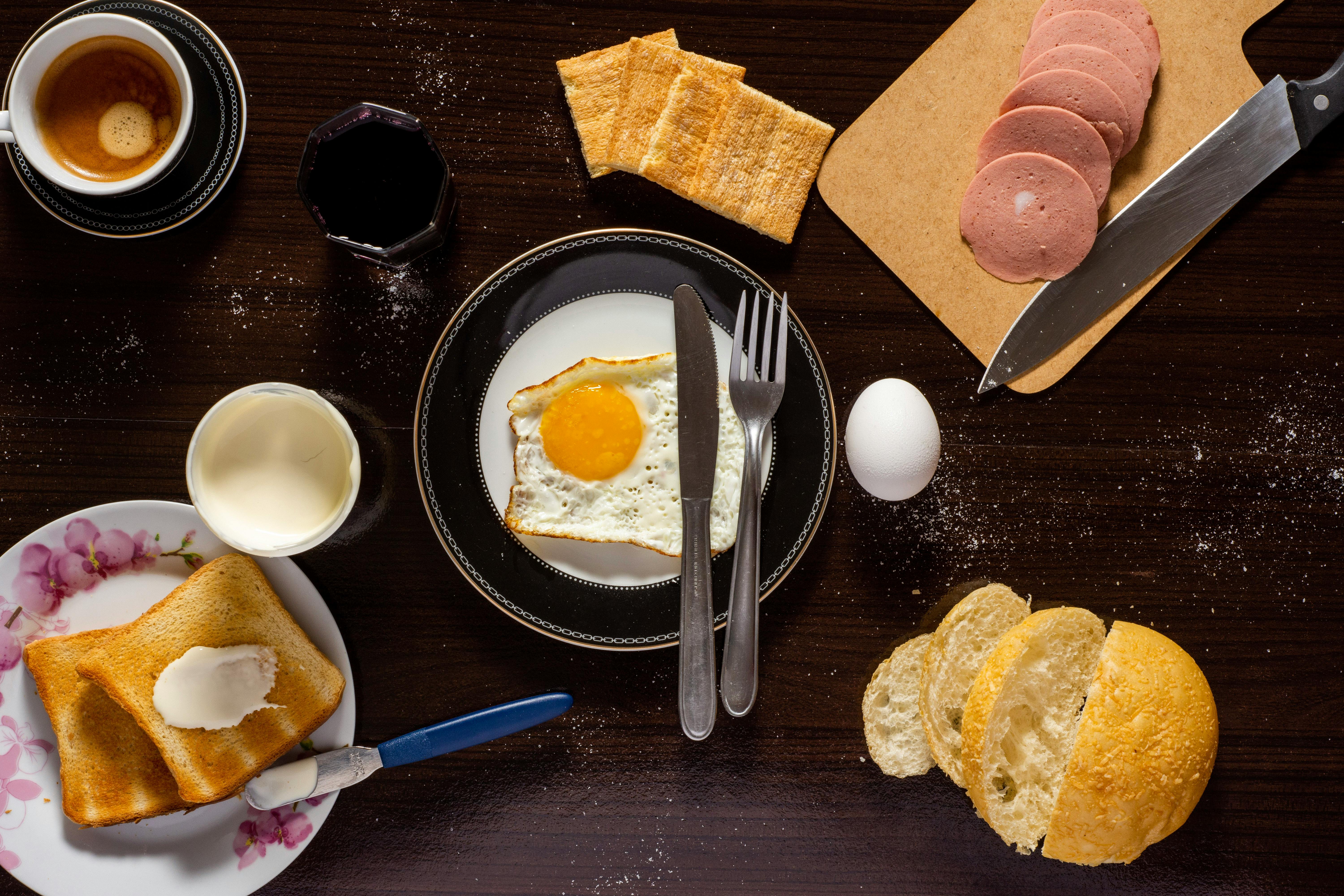 plate of sunny side up sliced meat and bread