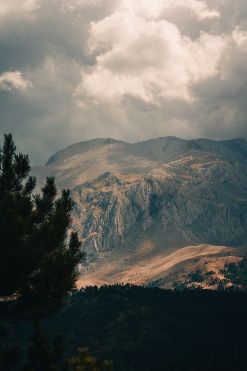 Free Scenic view of a rugged mountain under dramatic skies, perfect for travel and nature enthusiasts. Stock Photo