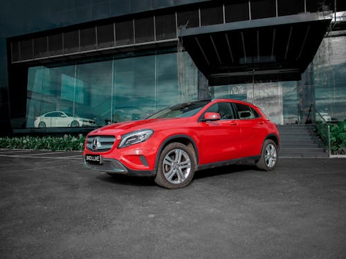 Red Car Parked Beside a Building