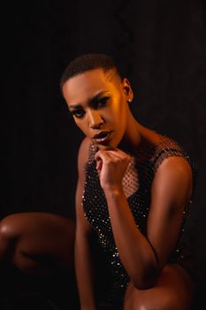 A striking portrait of a woman in a stylish outfit with dramatic lighting, exuding confidence.