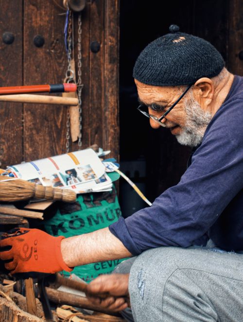 Free Senior man skillfully crafting wooden objects in a workshop. Stock Photo