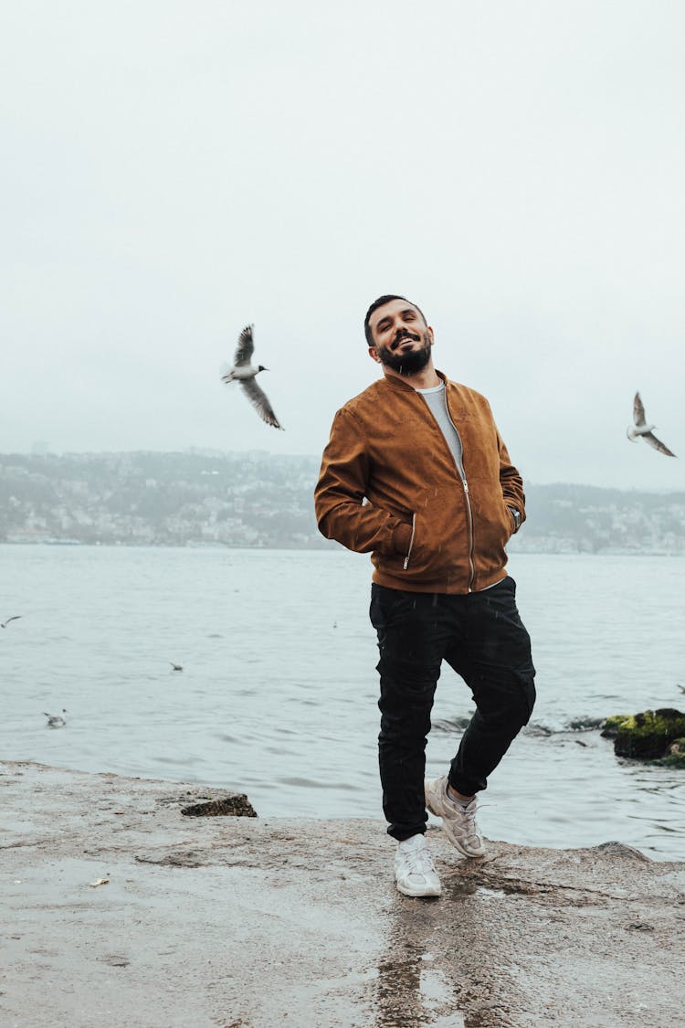 Bearded Man Walking On The Beach And Smiling 