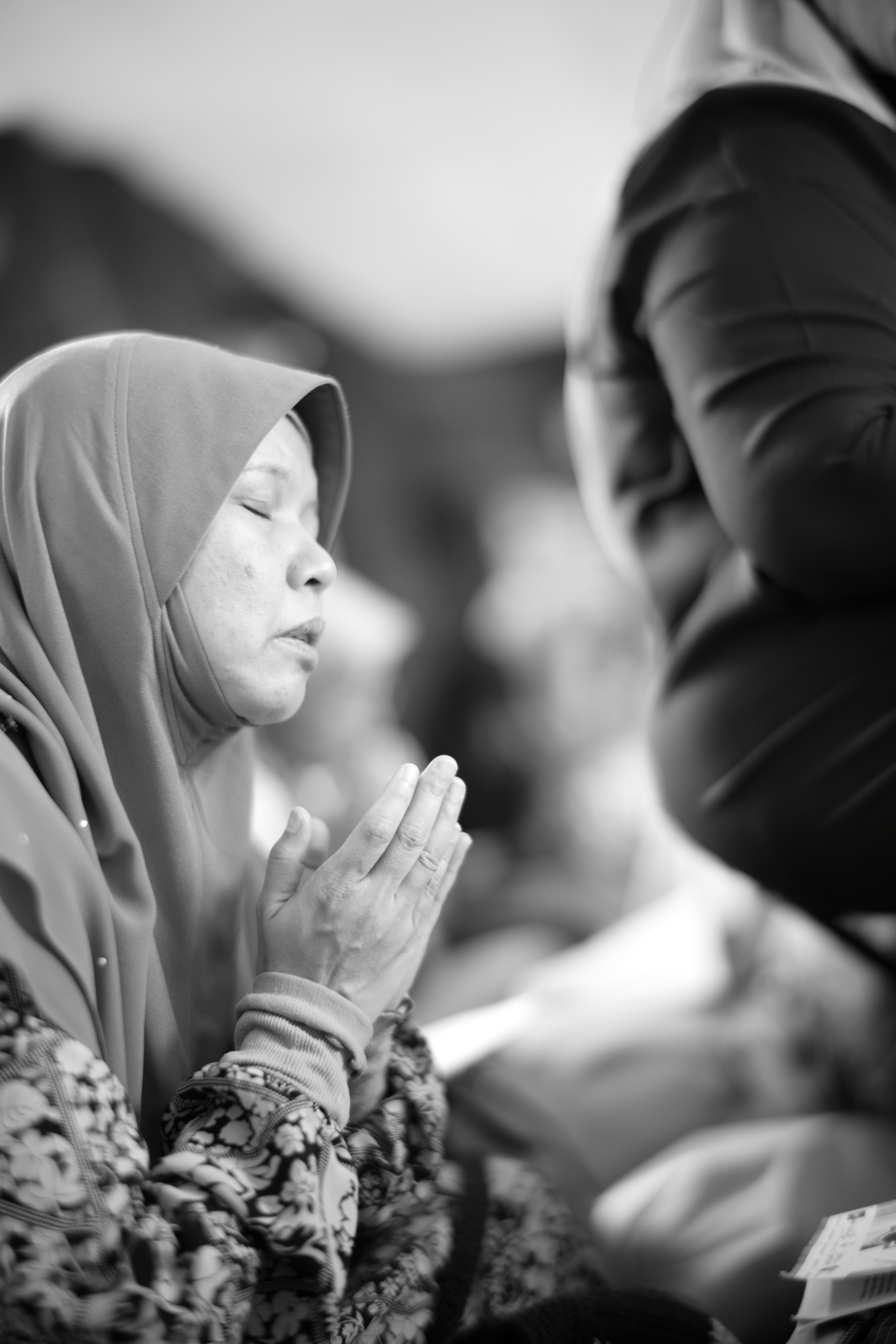 A woman in prayer, captured in a serene moment in Semampir, Indonesia.