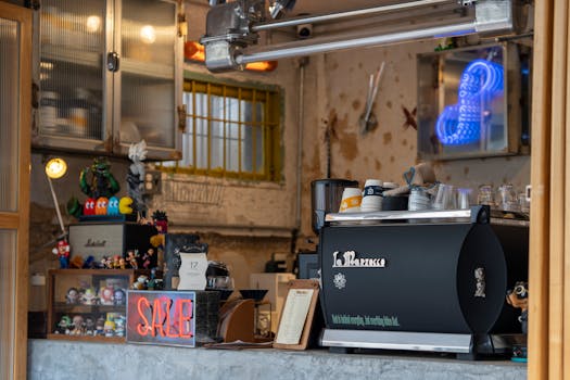 Cozy urban coffee shop with espresso machine, neon lights, and decorative items.