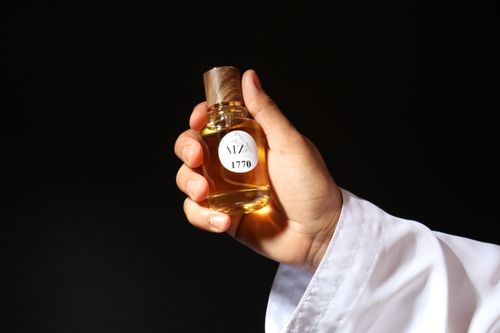 Free Close-up of a hand holding a luxurious whisky bottle, elegant and sophisticated. Stock Photo