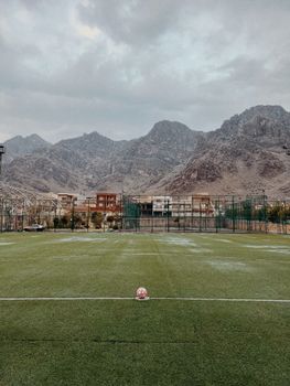 A picturesque soccer field with a mountain backdrop, perfect for sports imagery.