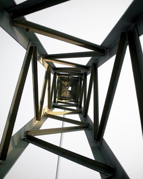 Dramatic view from inside a steel tower showcasing architectural geometry.