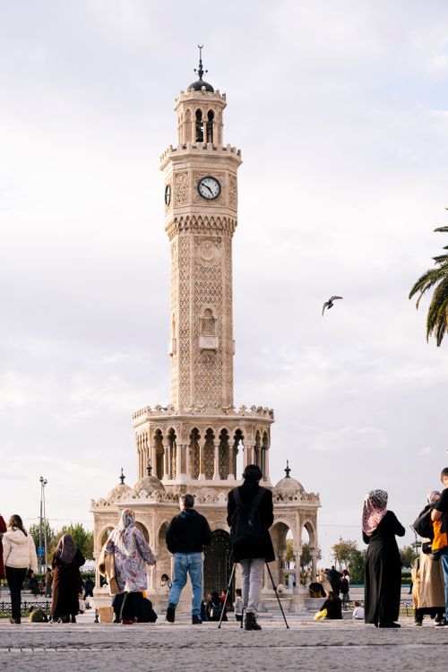 Free People gathered around the historic Ottoman Clock Tower at Konak Square, Izmir, Turkey. Stock Photo