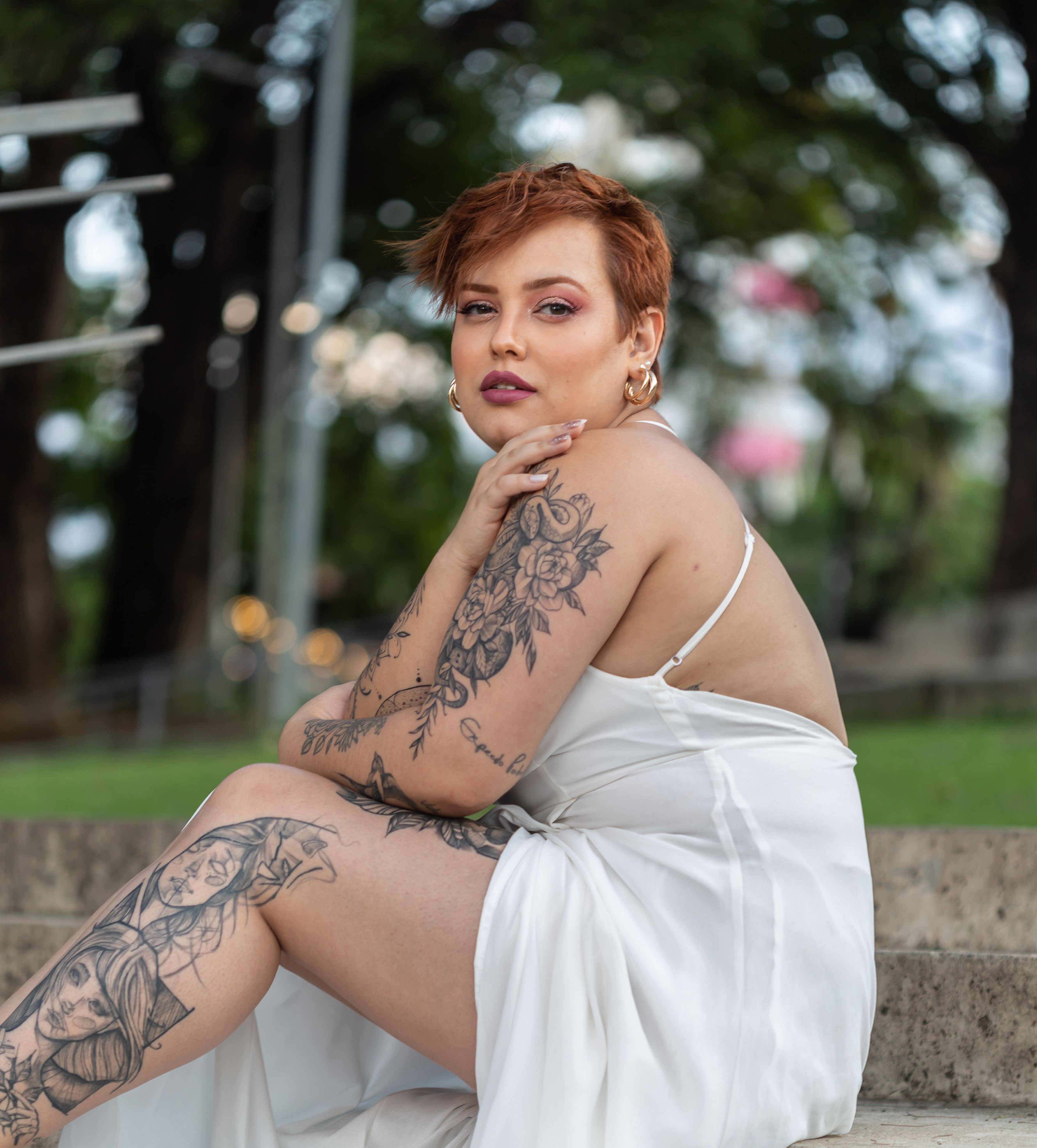 a-woman-with-tattoos-putting-on-stockings-free-stock-photo