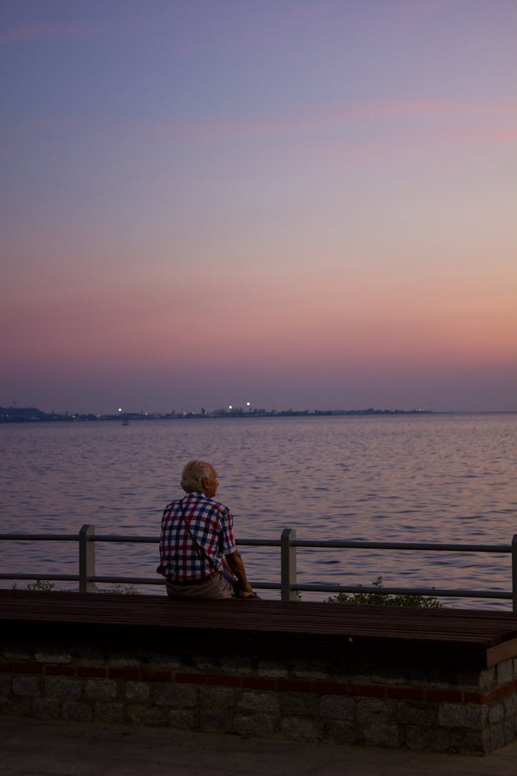 Elderly Man Sitting On The Bench