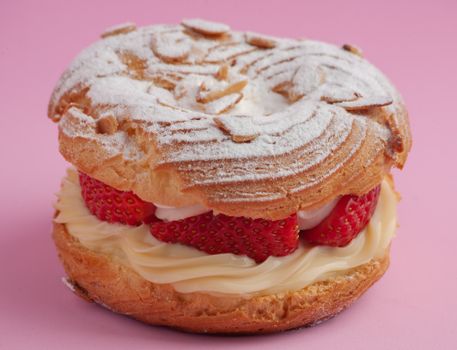 A Choux Pastry with Strawberries and Cream Filling with Powder Sugar on Top