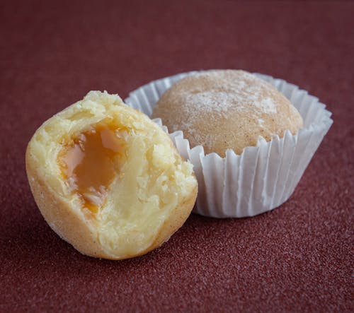 White and Yellow Pastry on Red Textile