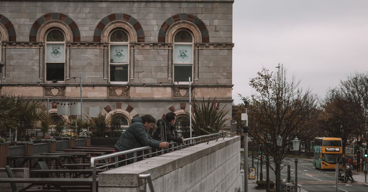 Street view overlooking a historic building and city life in Dublin, Ireland.