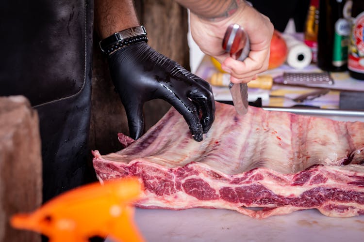 Person Holding Meat And Knife