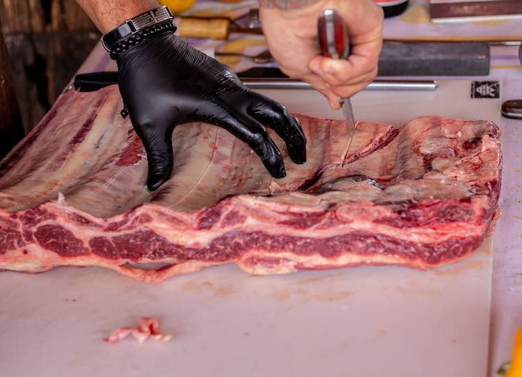 Person Holding A Raw Meat