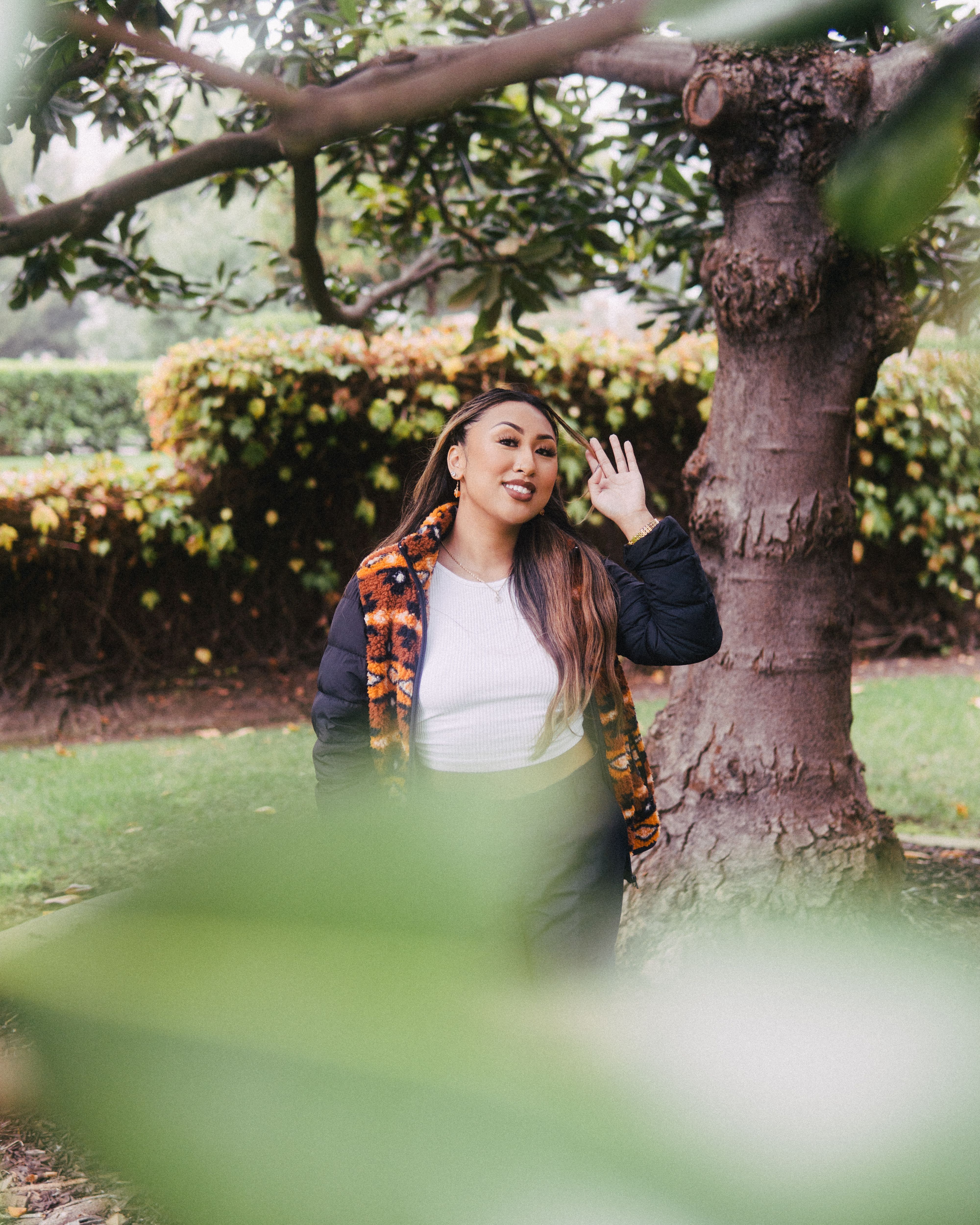 Woman in Black Leather Jacket Standing Beside Tree · Free Stock Photo