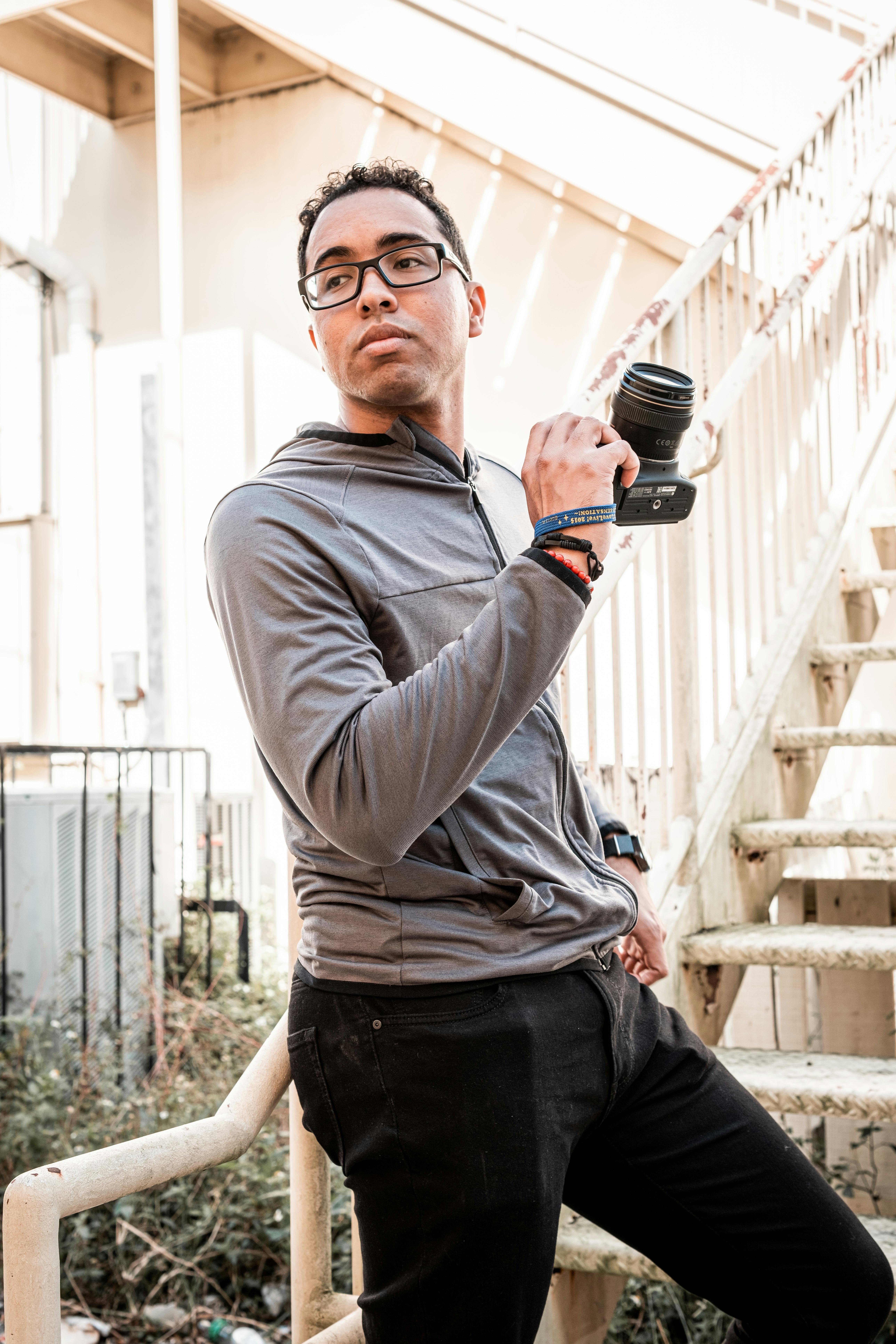 man in gray long sleeve shirt holding black microphone