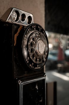 Close-up of an old rotary dial telephone with a nostalgic vibe, perfect for vintage themes.