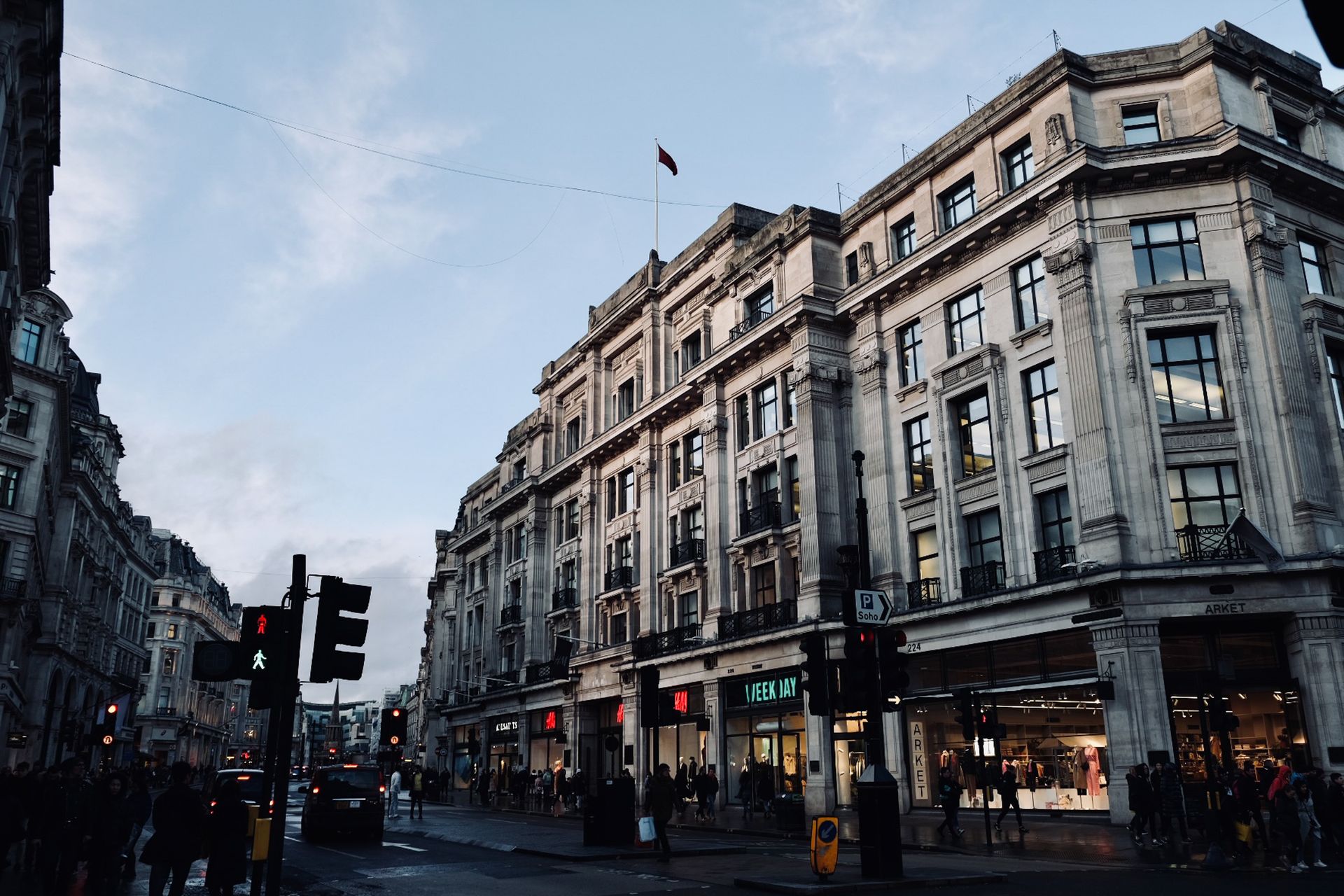 A shopping street in London with pedestrians walking