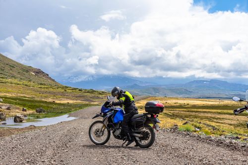 Free A motorcyclist explores the picturesque landscape of Neuquén, Argentina under a cloudy sky. Stock Photo