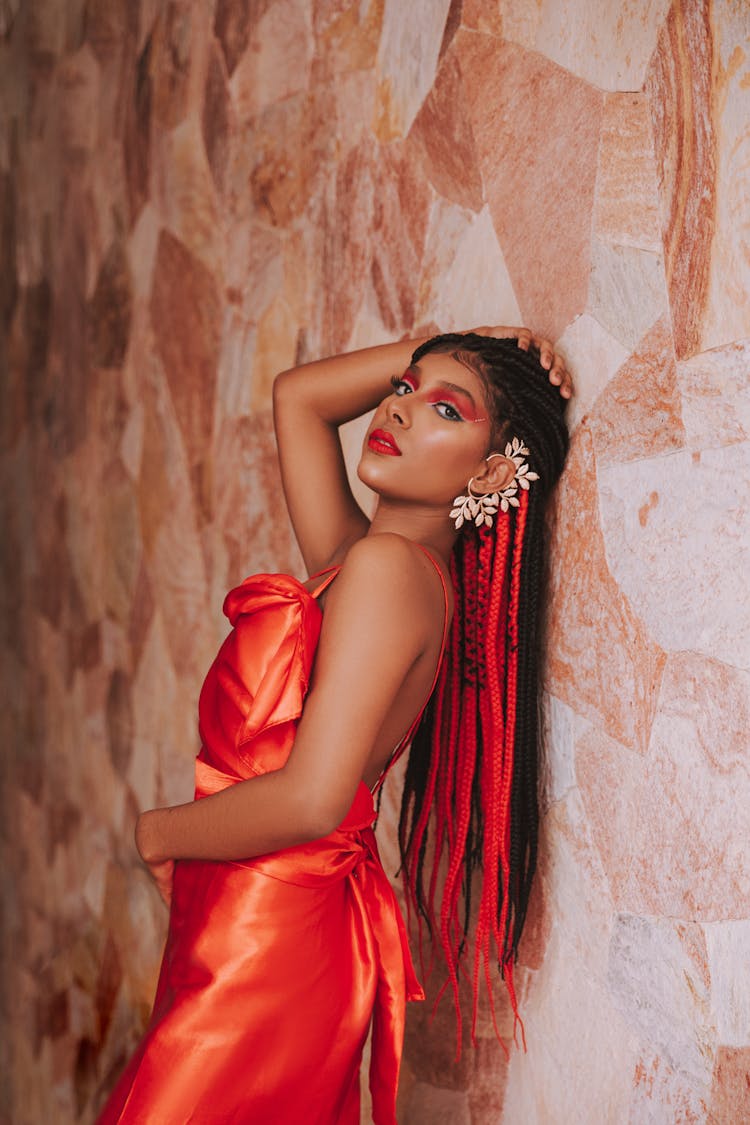 Woman In Dress Posing By Wall