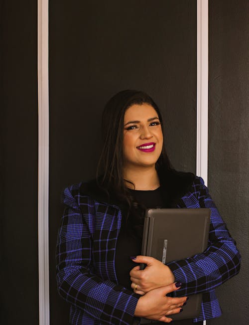 Smiling Woman Holding a Laptop