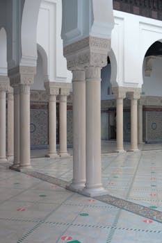 Beautiful Moroccan-style columns and arches in a Parisian courtyard. Captivating architecture.