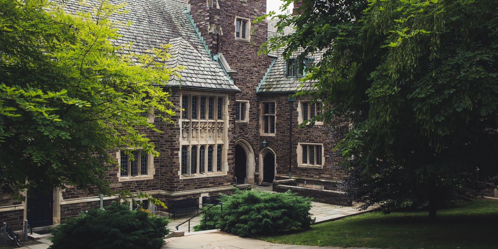 Elegant Gothic architecture of Princeton University surrounded by lush greenery on a summer day.