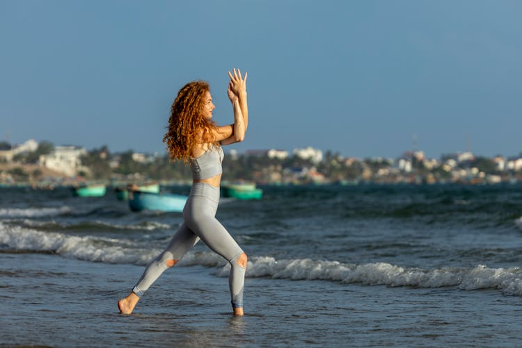 Woman Doing Yoga On Beach