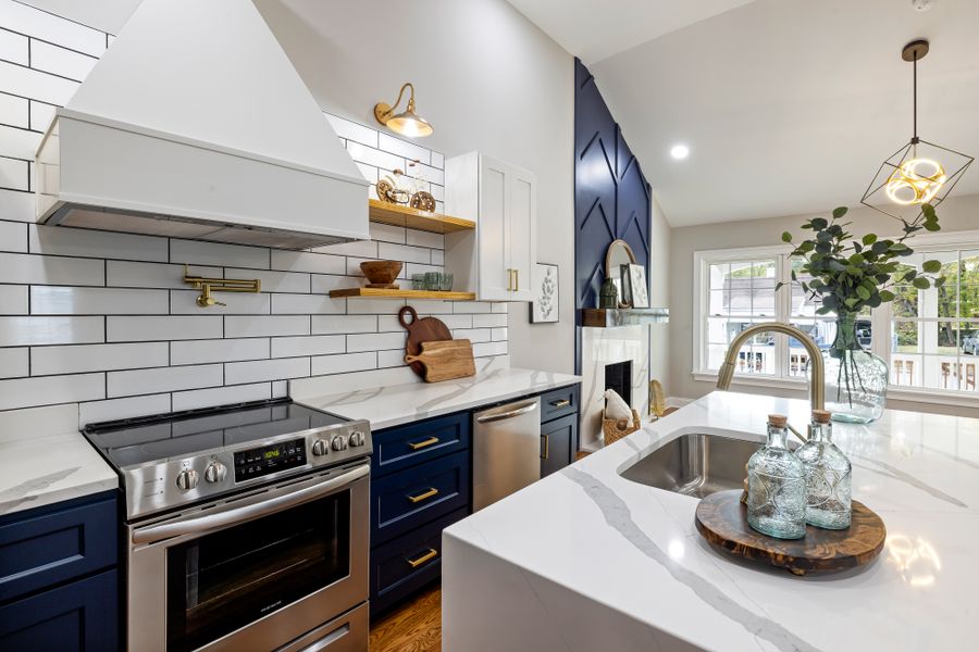 Kitchen with elegant blue cabinets and marble countertops