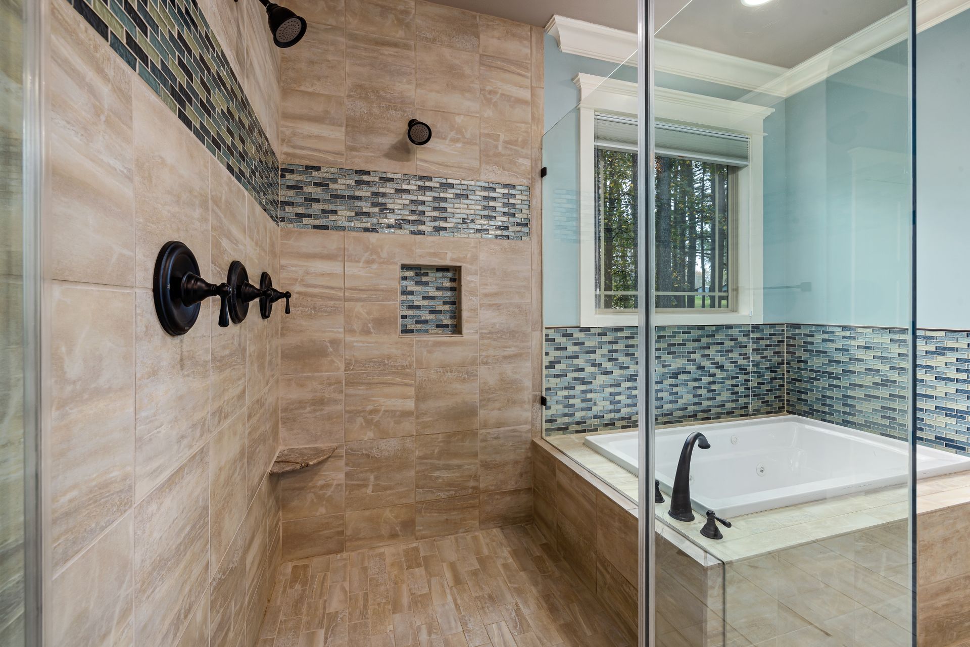Luxurious bathroom featuring glass shower, bathtub, and stylish tile design for modern interiors.