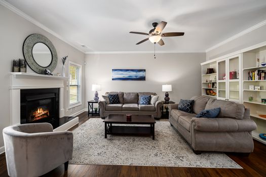 Stylish and cozy living room with a fireplace and comfortable sofas, perfect for relaxation.