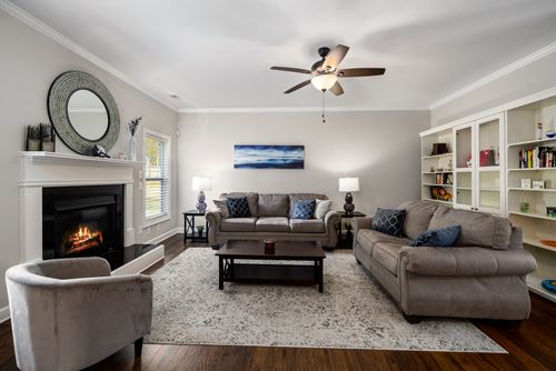 Free Stylish and cozy living room with a fireplace and comfortable sofas, perfect for relaxation. Stock Photo