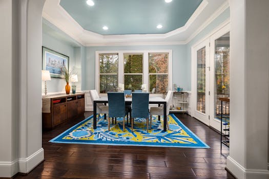 Bright and inviting dining room with modern decor and colorful rug.
