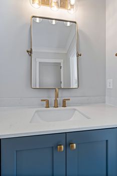Elegant bathroom with minimalist vanity, chic mirror, and modern faucet design.