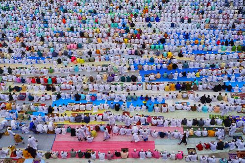 Free A vibrant aerial scene showing a community of people in traditional attire engaged in outdoor prayer in Howrah. Stock Photo