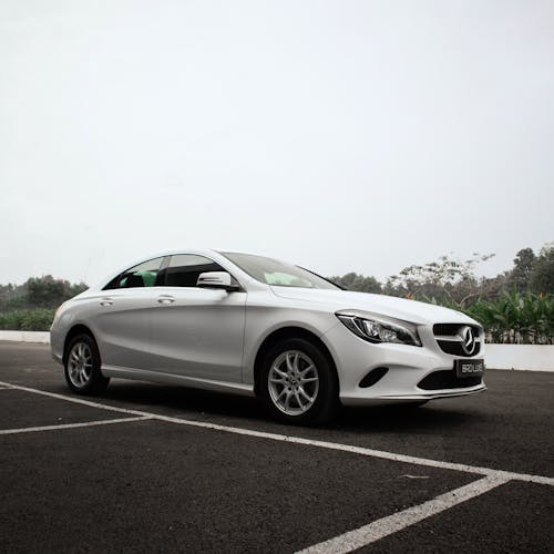 White Mercedes Benz on Concrete Pavement